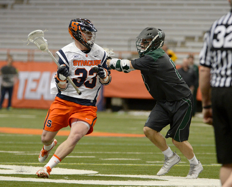 Scott Loy moves toward the net while a defender obstructs his path. Loy scored the decisive goal in third quarter that gave SU a 7-6 lead that it wouldn't give up. 