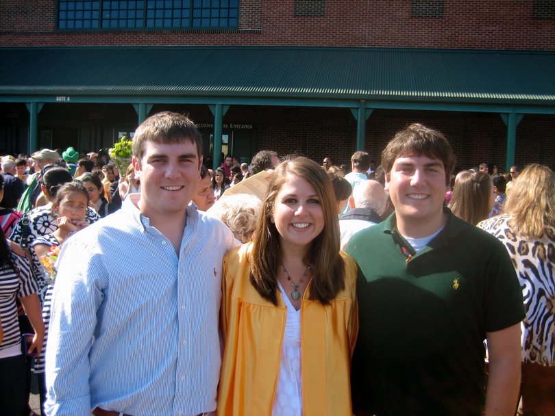 Abraham poses for a picture at her graduation between her brothers Robert (left) and Michael (right) at her high school graduation.