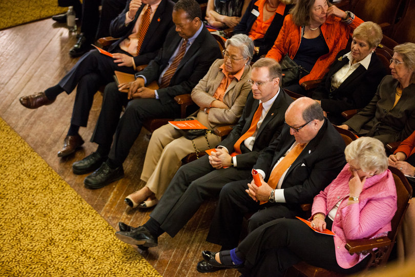 Chancellor Kent Syverud sits in the front row at the symposium with his wife, Ruth Chen, and Board of Trustees Chairman Dick Thompson.