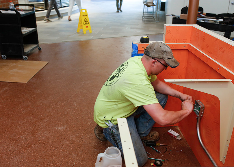 Michael Millard, an electrician, works on a check-in countertop in the lobby of Graham Dining Center, which underwent renovations this summer.