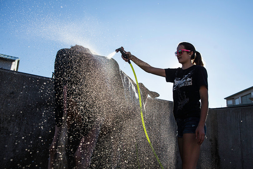 Cassie Head of Waterville washes her cow, "Juicy," outside of the Dairy Coffle Show.