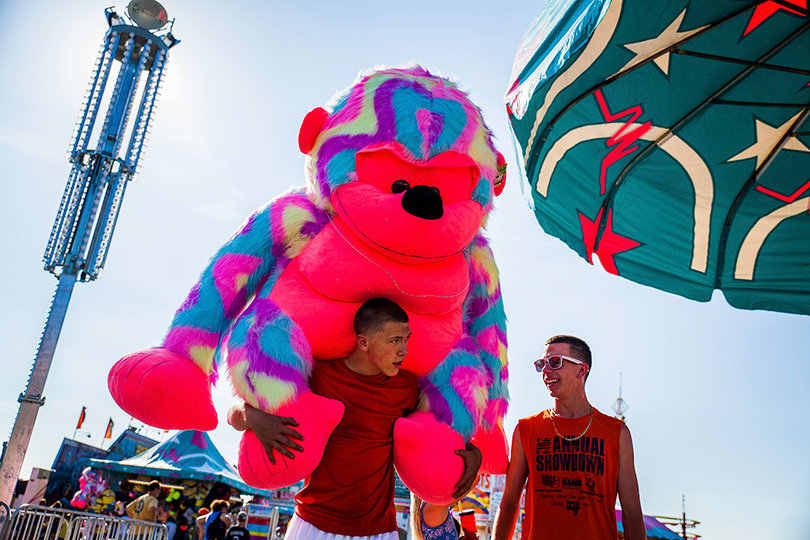 Cameryn Williams (left) carries a giant stuffed ape on his back, a prize his friend Nate Johns (right) won in a game at the fair. Like Williams, guests can win prizes at one of the many carnival game booths found throughout the fairgrounds.