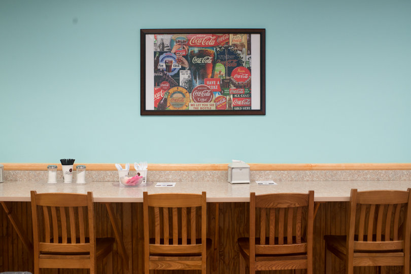 Customers can sit down at the long high-top counter after purchasing a local baked good from Hot Crouse Buns. The counter can seat up to nine people. 