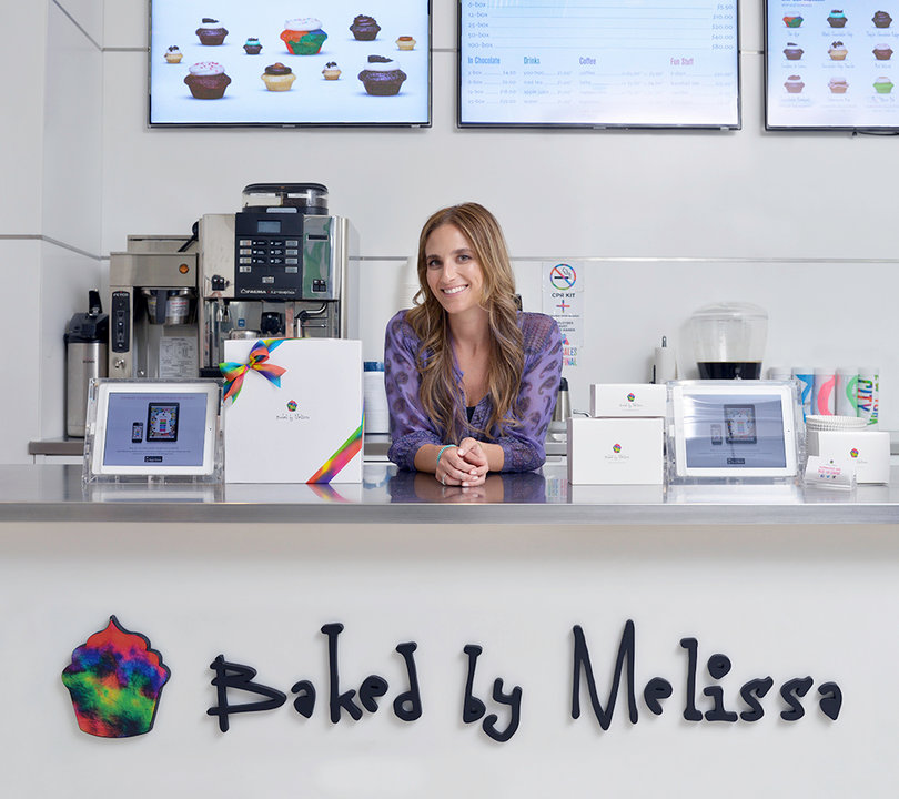 Melissa Ben-Ishay, a 2006 SU alumna, stands in her New York City store with her mini cupcakes. 