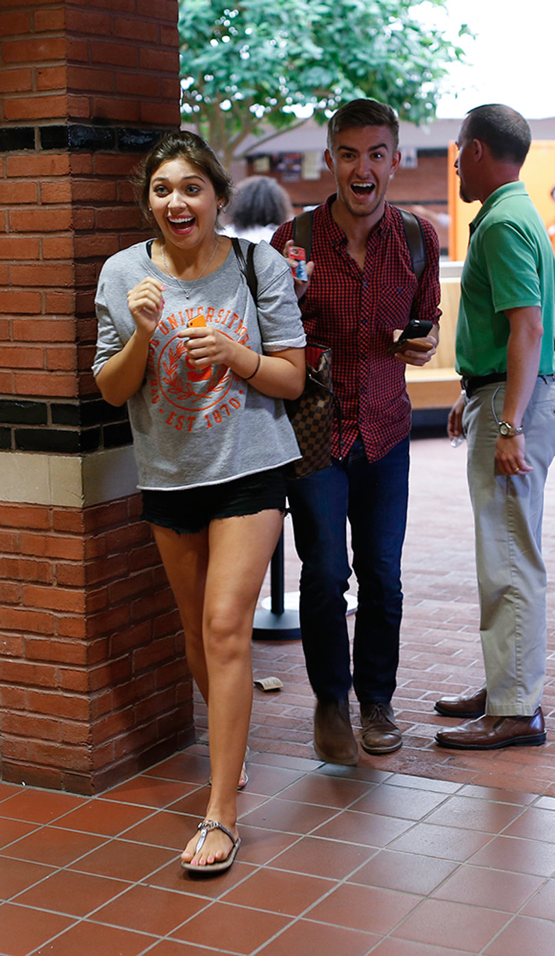 Brittany Muller and Aiden Meyer, both sophomores, walk into the Schine Box Office to pick up their free tickets.