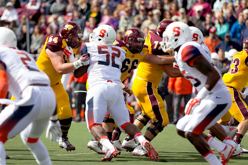 Syracuse nose tackle Eric Crume (52) looks to apply pressure on CMU.