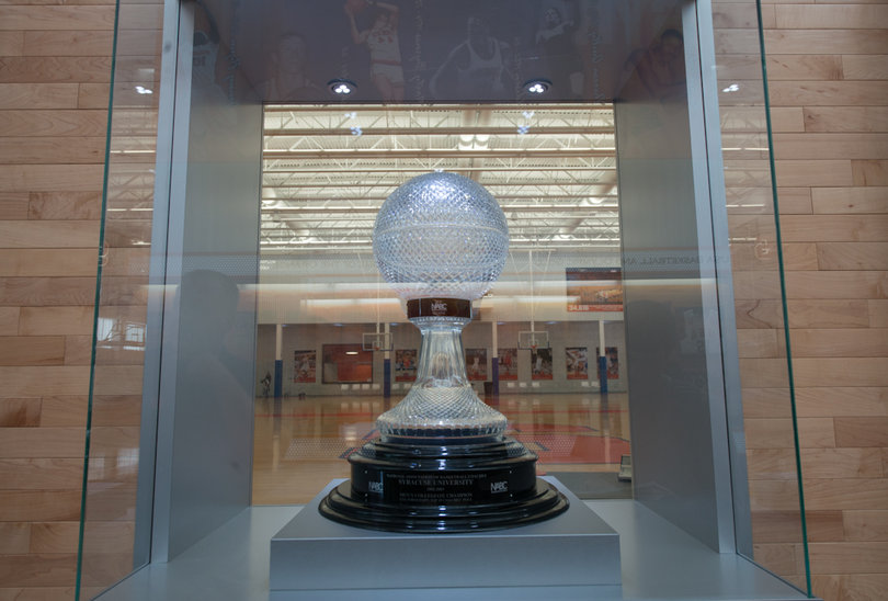 Syracuse won the national championship trophy in 2003 and it is showcased in the middle of the facility's hallway. When the lights turn off, the players still practicing can see it glow. 