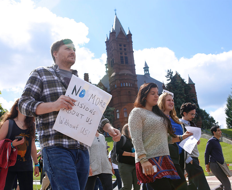 Jason Markins, a graduate student in the composition and cultural rhetoric studies program, marched with other protesters to the chancellor’s office on Wednesday. Markins held a sign that said, "No more decisions about us, without us!"