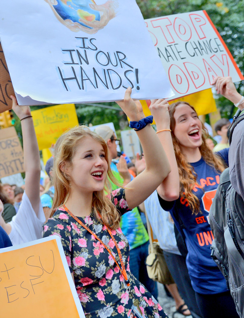 Kristen Koniuch (left), a freshman pre-law and environmental studies double major and Julia Jesse (right), a  freshman engineering major hold signs during the People's Climate March in New York City on Sunday. The protest was held to ask for more action to address climate change.
