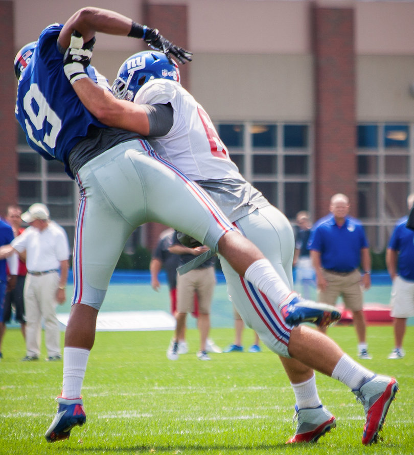 Pugh delivers a pancake block at training camp on July 27. In just the second year of his NFL career, Pugh is already being called on to be a leader for a transformed offensive line.