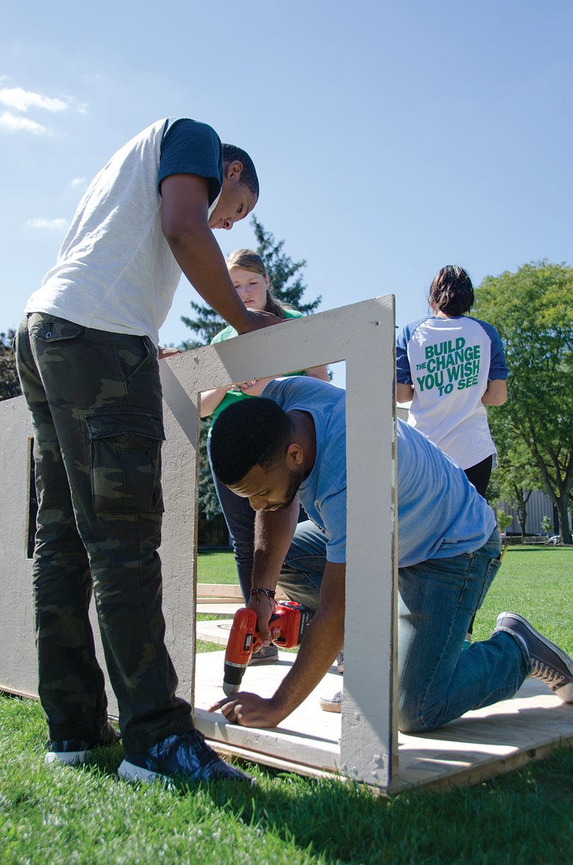Juniors Josue Luna, an IT major (right), and Wilfredo Castillo, an international relations major (left), work on building the Lambda Upsilon Lambda shack on the quad.
