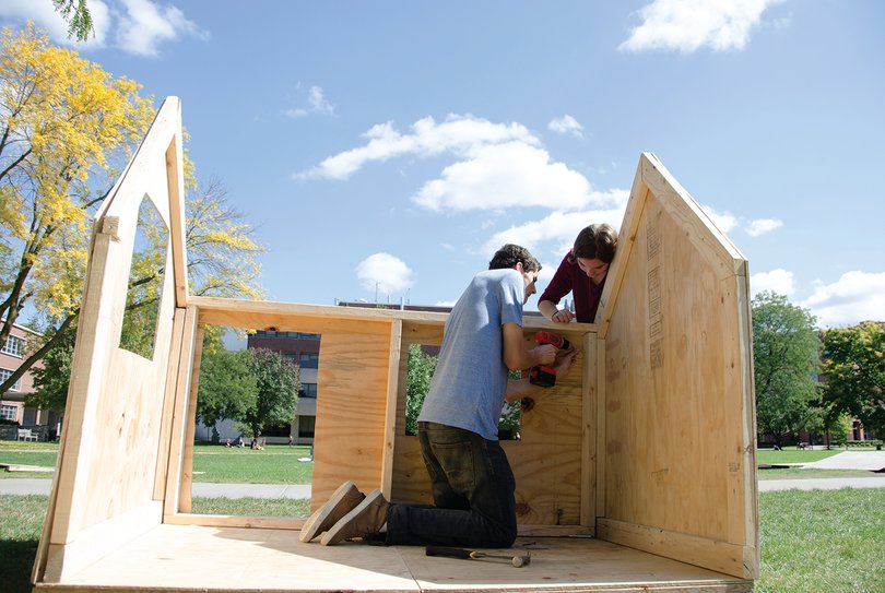 Serena DeSeta, a freshmen dual public relations and management major, and Sam Sinykin, a communication and rhetorical studies major, work on the Orange Seeds shack, a freshman leadership program on campus.