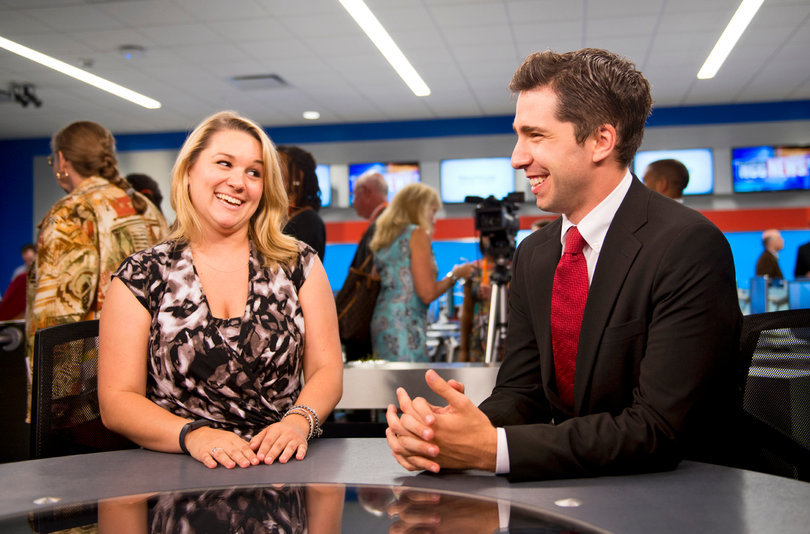 Robin Deehan and Andrew Polino, both graduate students studying broadcast and digital journalism, stand inside the newly renovated studios in Newhouse II.