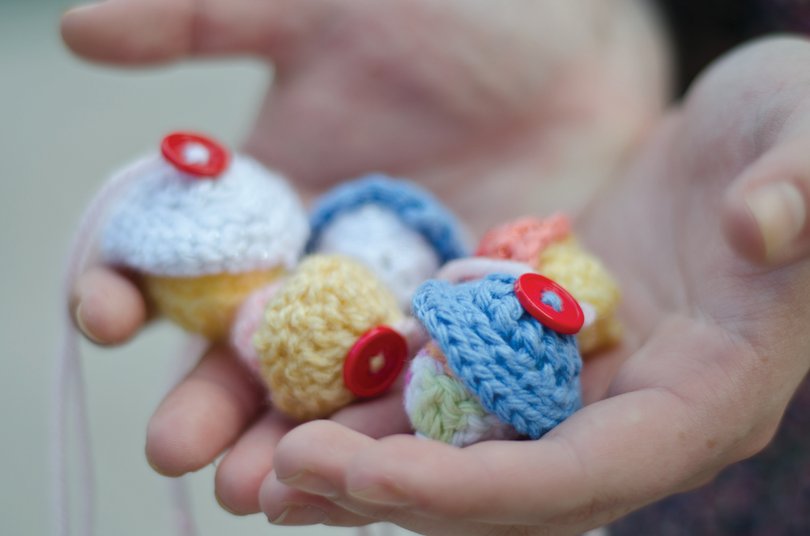 Lindsey Moskowitz, a fourth-year industrial and interactive design student, holds the cupcakes she crocheted for her class's craftivism project. 