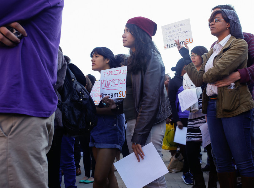 Students hold posters during the "Rally for a Difference" demonstration in front of the Life Sciences building on Sept. 19, 2014.