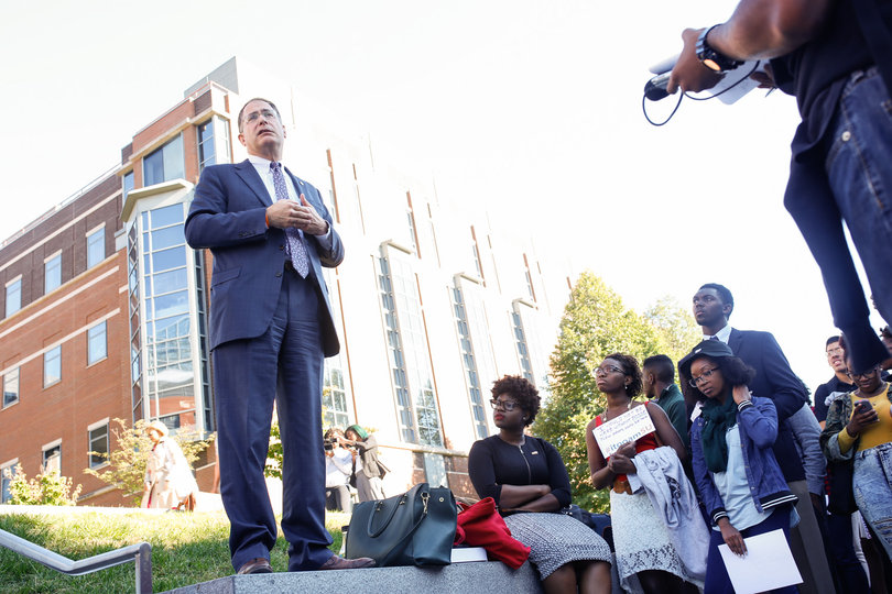 Eric Spina, vice chancellor and provost, speaks with protesters outside the Life Sciences building during the "Rally for a Difference" demonstration in front of the Life Sciences building on Sept. 19, 2014.