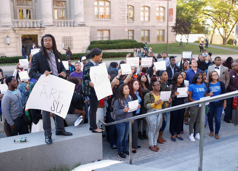 David L. Jackson, a history and secondary education sophomore, poses with students for a photo in front of the Life Sciences building during the "Rally for a Difference" demonstration on Sept. 19, 2014.