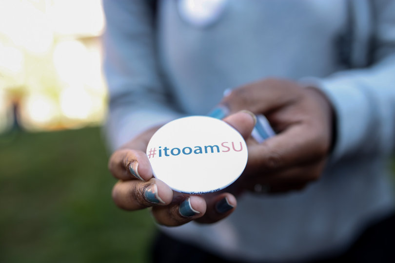 Stephanie Conn, a senior mathematics major, holds an #itooamSU button. The buttons were sold for two dollars each during the "Rally for a Difference" demonstration in front of the Life Sciences building on Friday.