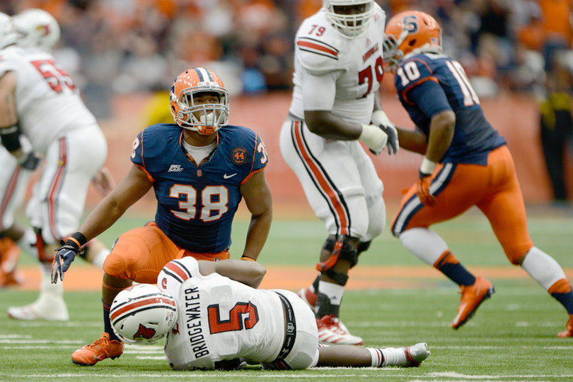 SU linebacker Cameron Lynch hovers over Louisville quarterback Teddy Bridgewater in 2012.
