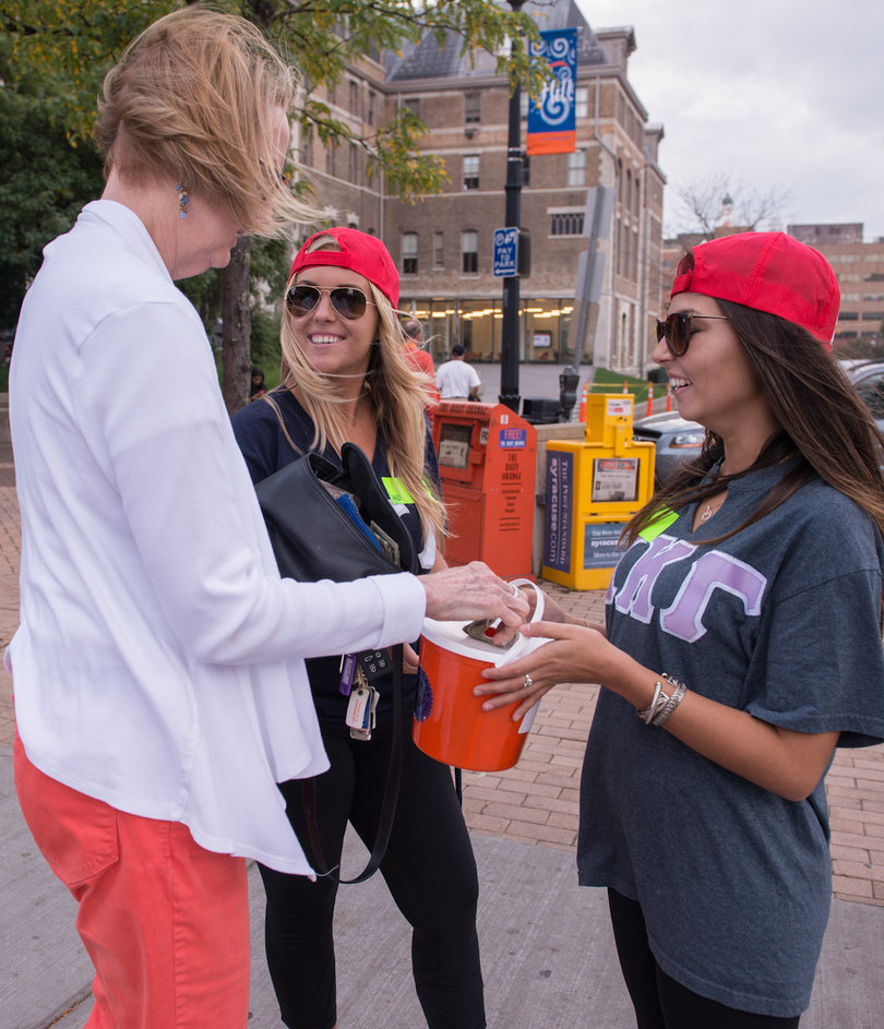 (From left) Sherri Taylor, a multimedia, photography and design professor, Molly Birman, a senior public relations and marketing major, and Tara Tiemann, a senior history and political science major, take part in Dollar Day. The annual event took place before Friday's football game against the University of Louisville.