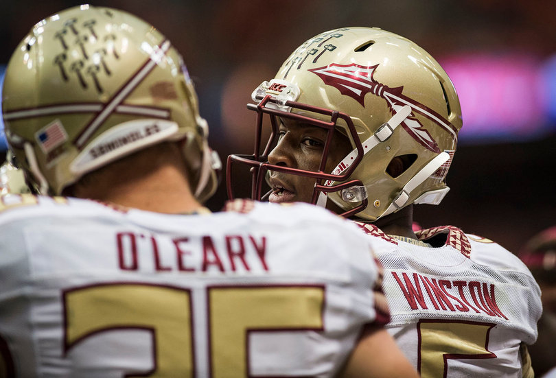 Florida State quarterback Jameis Winston and tight end Nick O'Leary talk on the sideline.  