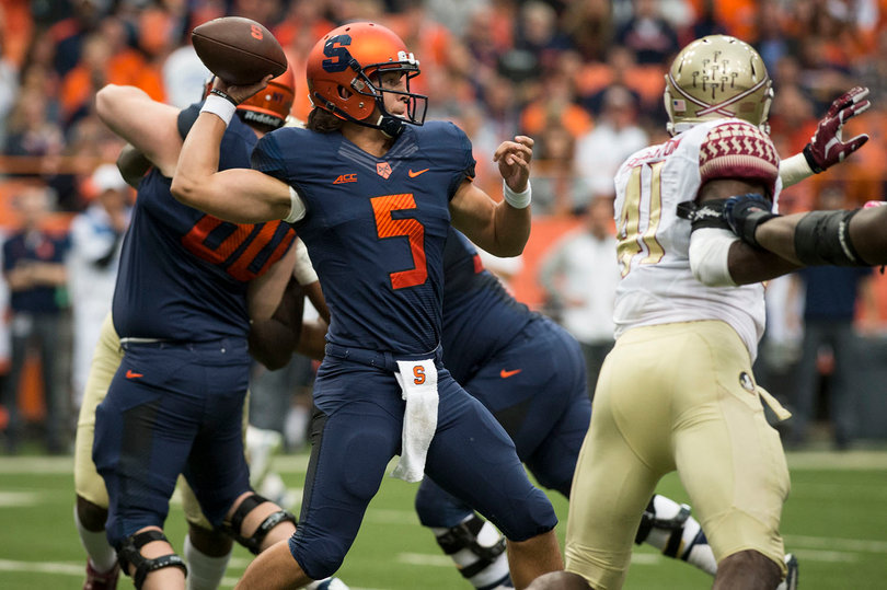 Syracuse quarterback Austin Wilson winds up to throw as Florida State closes in on the pocket. 