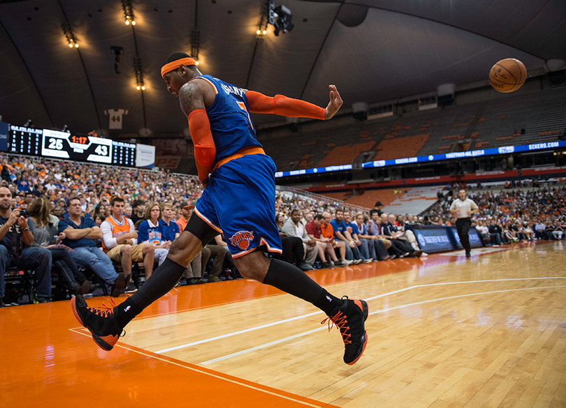 Anthony saves a ball from going out of bounds while a familiar crowd looks on. 