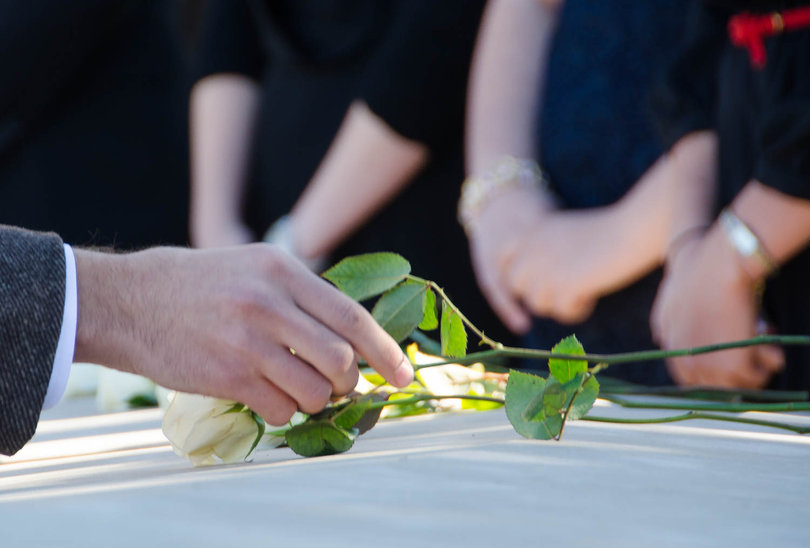 Elliott Russell, a bioengineering and biotechnology dual major and Remembrance Scholar, places his rose to represent Alexia Tsairis, the 20-year-old Syracuse victim who inspired the establishment of the Alexia Foundation. 