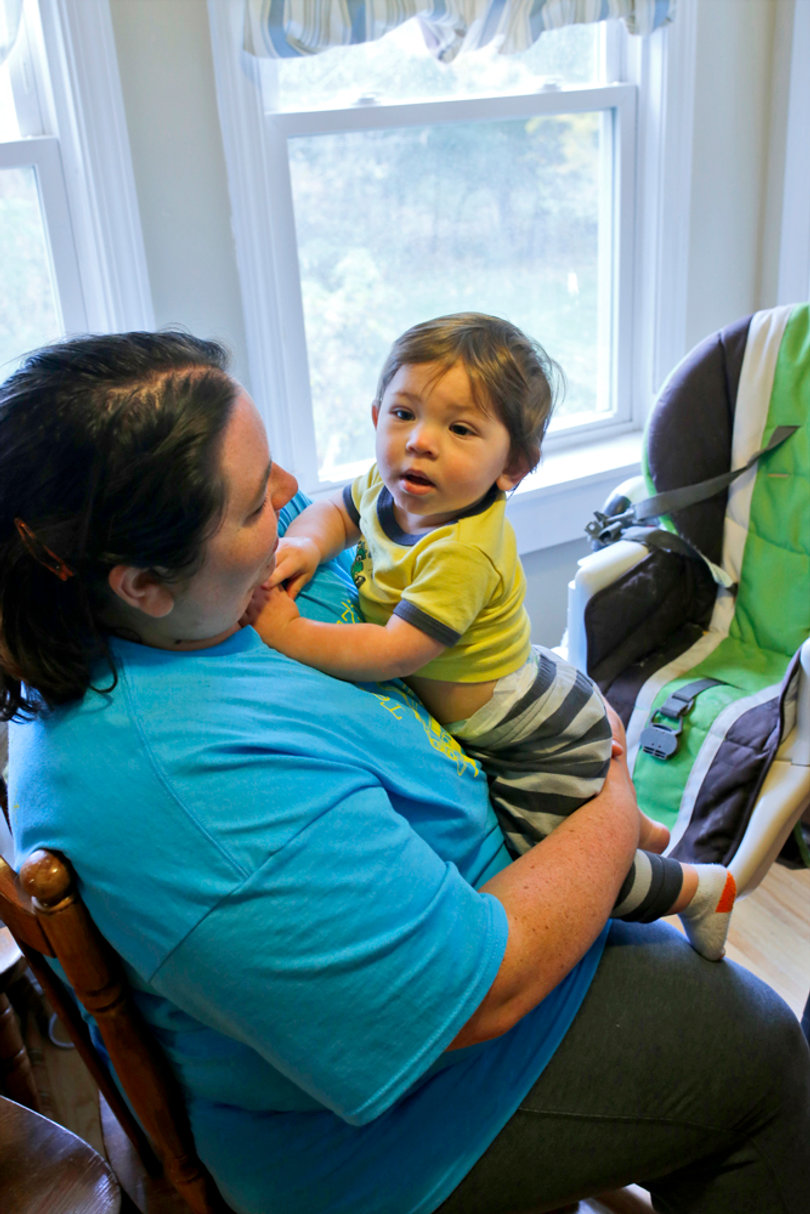 O'Dell holds her son. A new grant gives graduate students money for child care, but some are questioning if it's enough. 