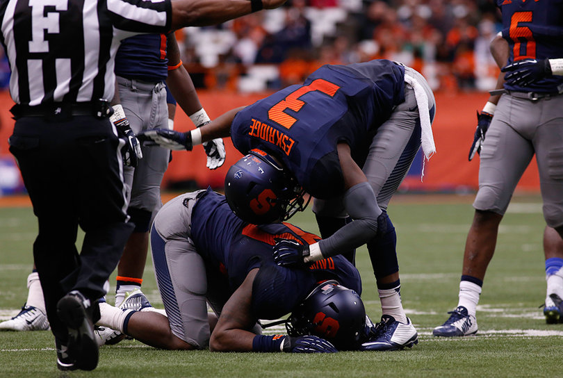 Orange safety Durell Eskridge (3) hovers over Davis after the linebacker missed out on an interception.