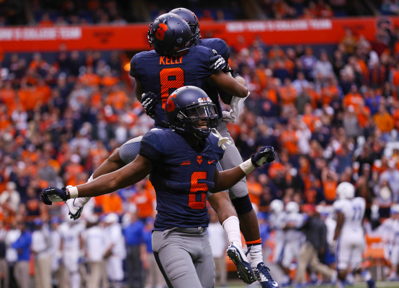 Safeties Kelly and Ritchy Desir celebrate a defensive stop. 