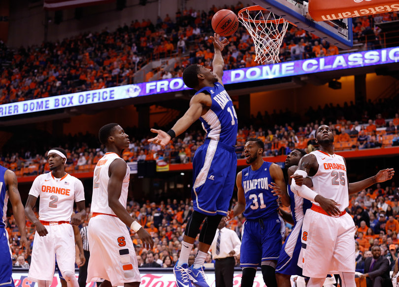 Hampton's Brian Darden attempts a finish as Tyler Roberson (second from left) and Rakeem Christmas (right) watch on.