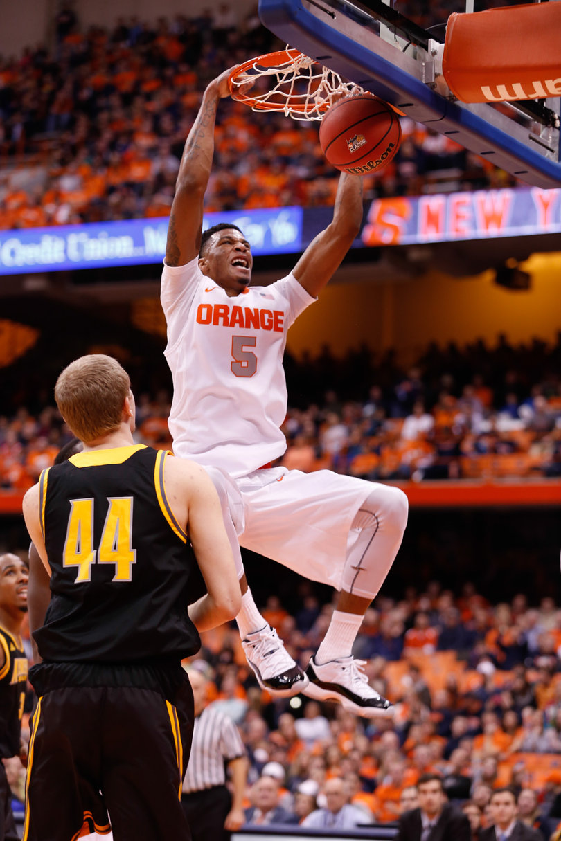 Orange freshman forward Chris McCullough finishes a two-handed dunk as Kennesaw State's Justin Diecker watches.