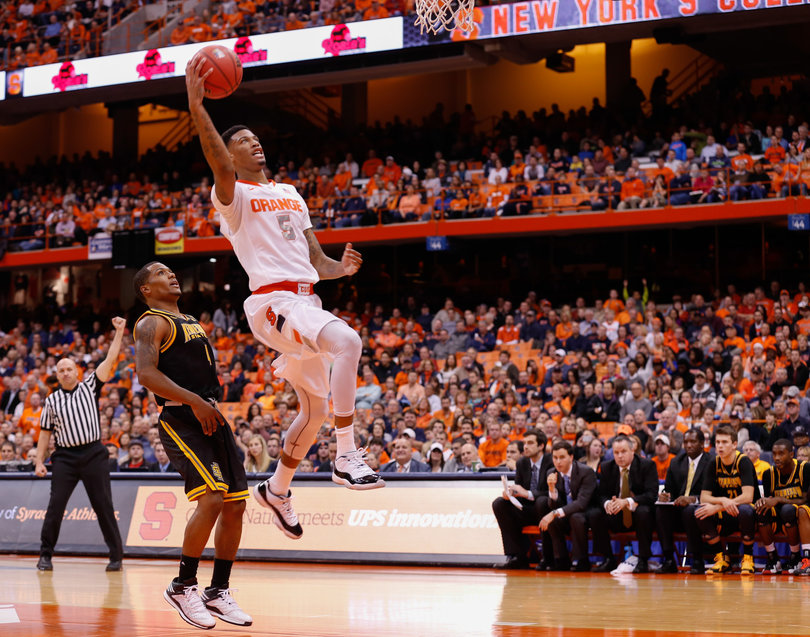 McCullough attacks the basket as an Owls defender watches.