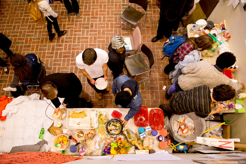 Members of THE General Body receive donated food from their supporters for their meals during the sit-in.