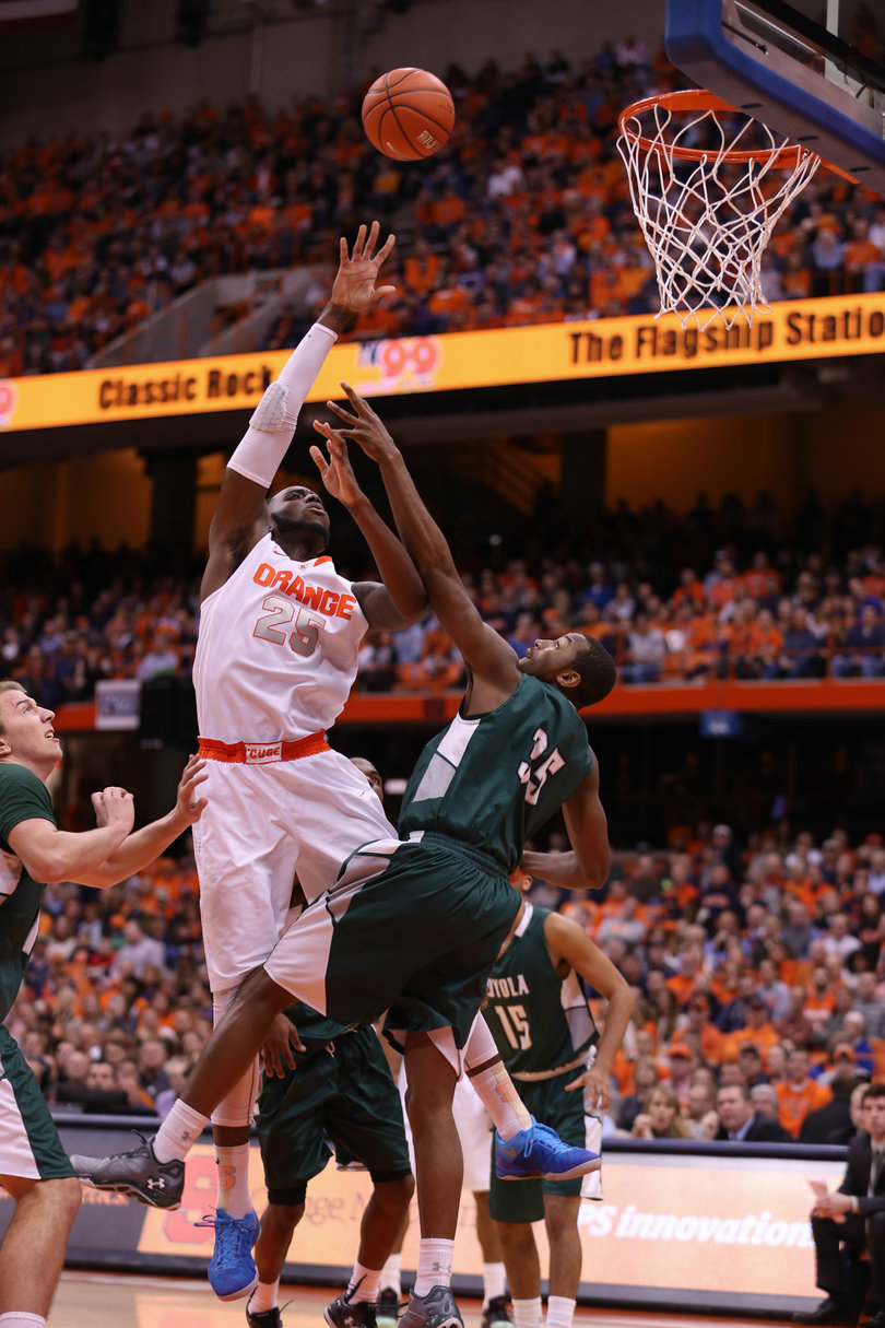 Christmas flicks a shot over Loyola guard Chancellor Barnard from the paint.