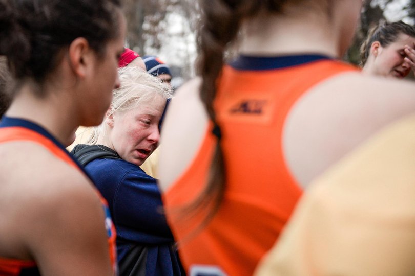 Sophomore forward Serra Degnan wipes away tears as Syracuse huddles after its title-game loss.