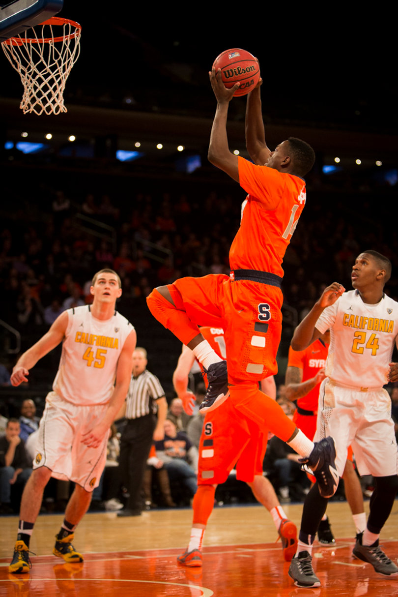Point guard Kaleb Joseph rises up for a layup as California's David Kravish (left) and Jordan Mathews (right) look on.