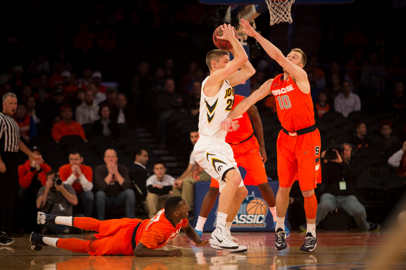 SU shooting guard Trevor Cooney pressues an Iowa player as Joseph pushes himself off of the floor. 