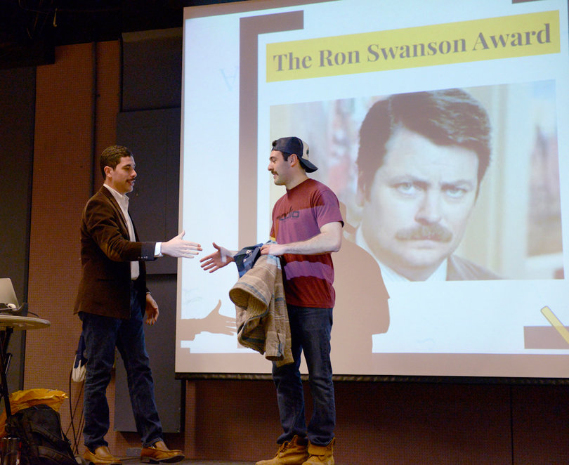 (From left) Evan Konecky and Kip Nairin shake hands at the Stache Bash. SU Greek organizations have raised over $12,500.