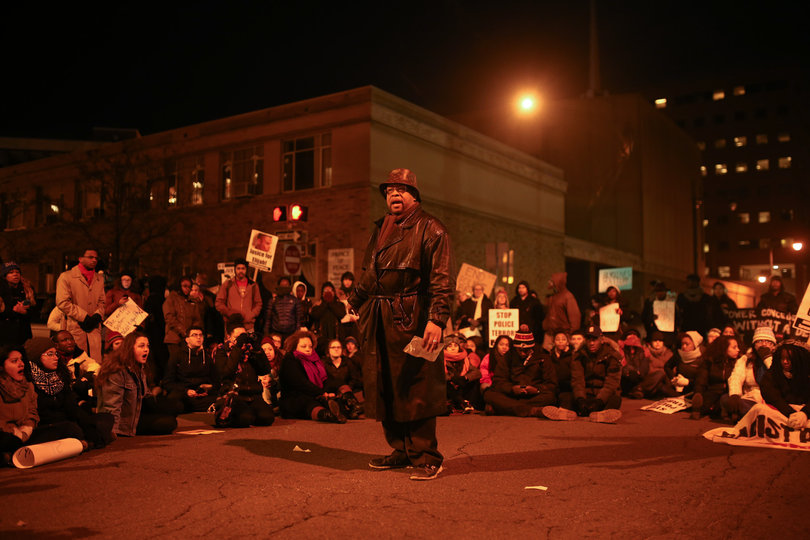 Pastor Micah Dexter speaks about his own personal experience with members of the police force in front of the Patrick J. Corbett Justice Center during Monday's "March for Justice." 