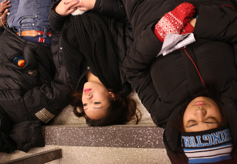 Kira Tran, a sophomore biomedical physics and women's and gender studies major, takes part in a "die-in" in Bird Library Monday afternoon.