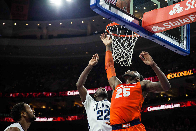 Christmas and JayVaughn Pinkston fight for a ball bouncing on the rim. Pinkston got the better of Christmas on the day, amassing 25 points and 10 rebounds.