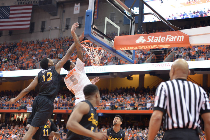 LBSU forward Eric McKnight goes for the block as McCullough tries to lay the ball in.