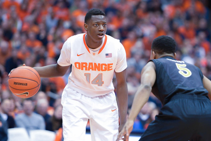 Joseph surveys the floor while being defended by senior Mike Caffey.
