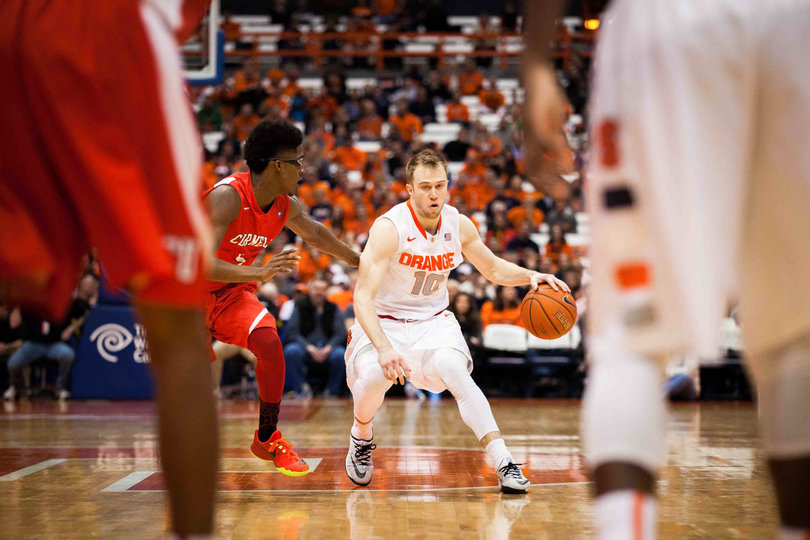 Cooney shields off Hatter while dribbling with his left hand. The junior turned in another solid performance, totaling 14 points, four rebounds and four assists.