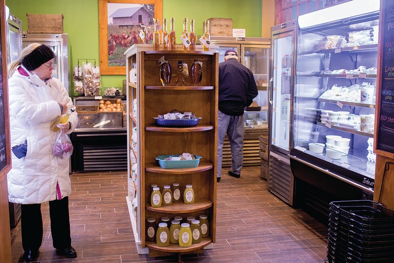 Customers shop at Side Hill Farmers, located in Manlius, New York, for fresh produce and prepared foods. The shop’s meat is grown without hormones or antibiotics.