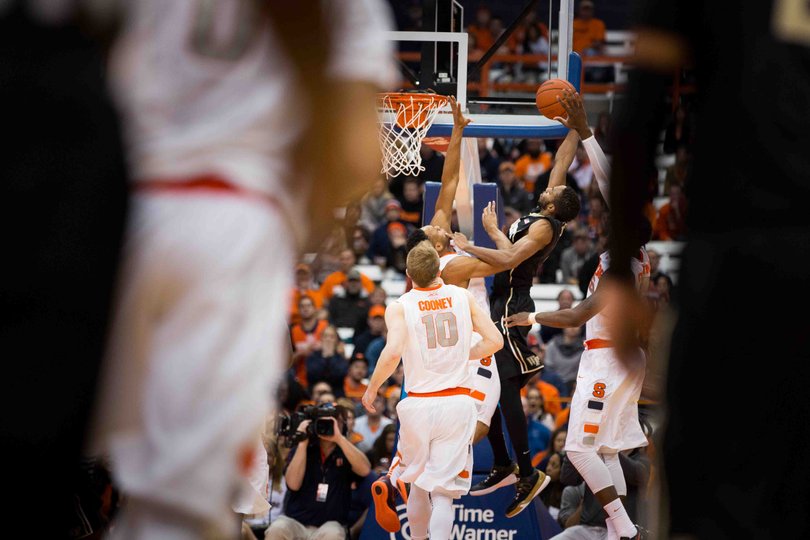 Cooney looks on as a Wake Forest player attacks the rim.