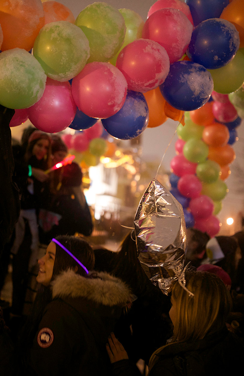 Balloons in front of Alpha Phi sink under the weight of snow while sisters celebrate in the sorority's front yard. 