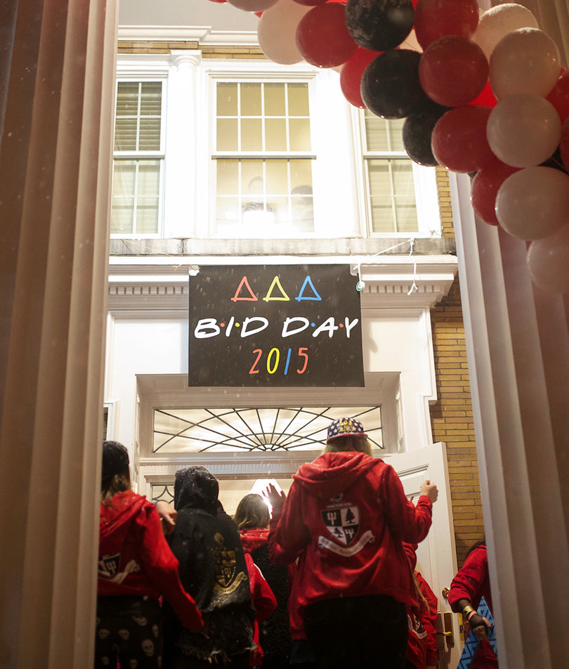 Sisters file into the Delta Delta Delta house on Walnut Place. 